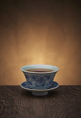 Traditional tea ceremony accessories, teacup with wooden background