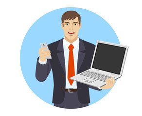 Businessman with mobile phone holding laptop notebook