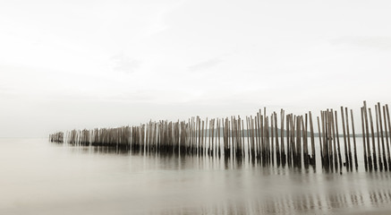 Bamboo wall in the sea, long exposure style.