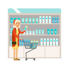 Old Lady In Pharmacy Choosing And Buying Drugs And Cosmetics, Part Of Set Of Drugstore Scenes With Pharmacists And Clients