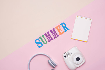 Summer fun written in colorful wooden letters on pastel color background.
