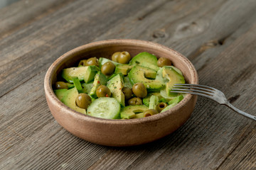 portion of vegeterian salad with olives, avocado