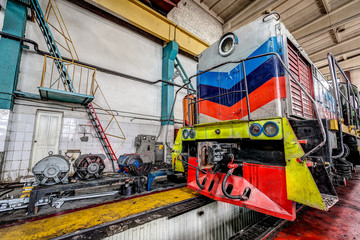 big russian locomotive in the repair workshop for old trains