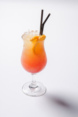 Tequila sunrise cocktail with ice on white background. Isolated