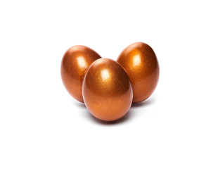 Small gold decorated Easter eggs isolated on a white background.