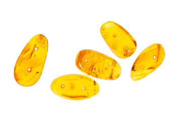 Yellow amber stones on a white background.
