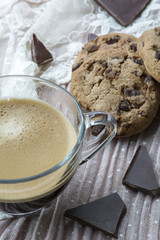 One glass cup of espresso with cookies with dark chocolate on the pink background