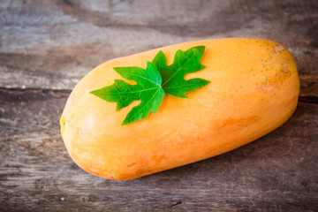 Ripe papaya on wooden background.