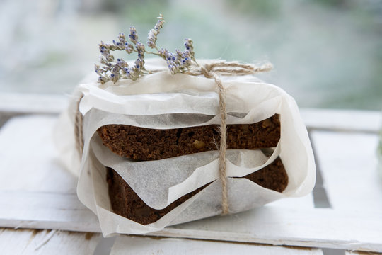Homemade brownies wrapped in paper lying on white background. selective focus