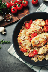 Frying pan with delicious chicken marsala on table