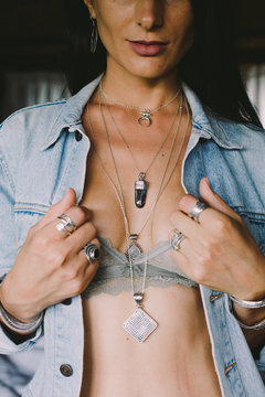 Woman in blue denim jacket with crystal pendant