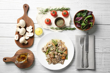 Plate with delicious chicken marsala and mushrooms on table