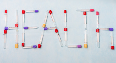 Test tubes for laboratory diagnosis, for blood tests оn a blue background .  From the test tubes, the word 