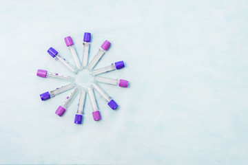 Test tubes for laboratory diagnosis, for blood tests on a blue background .  Tubes are arranged in...