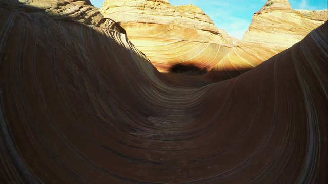 Gliding view walking through the Wave as the sun lights up part of it.