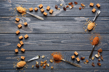 Composition with brown sugar on wooden background