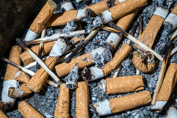 Bad addiction. Ashtray and cigarettes close-up.