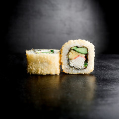Sushi rolls isolated on dark background. Japanese food