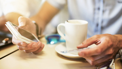 Man paying with credit card on smart phone
