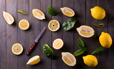 Fresh lemons on rustic wooden background.
