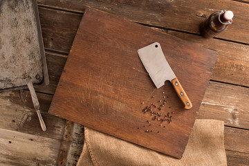 Butcher. Old chopper knife on a cutting board background.
