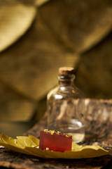 Close up of a piece of lime with marmalade and spices on the bark of a tree. Snack for alcoholic cocktails.