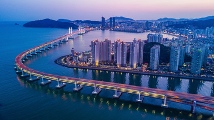 Busan Gwangandaegyo Bridge or GwangAn Bridge building skyline at Haeundae, Aerial view at night...