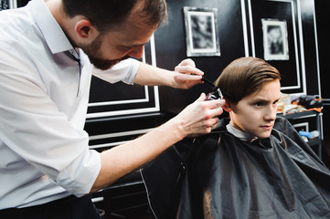 cute young boy getting a haircut