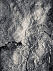 Macro closeup detail on black rough structure mineral, natural grungy textured background