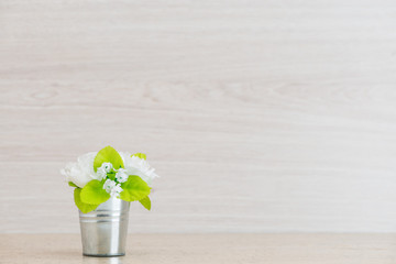 Floral arrangement of fresh flowers on a wooden background with space for text