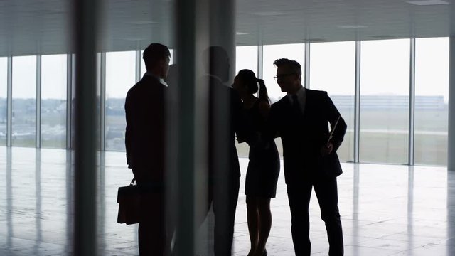  Business team viewing empty commercial property & shaking hands with agents