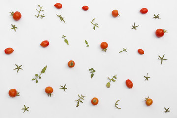 tomatoes and leaves pattern on white background. Flat lay.