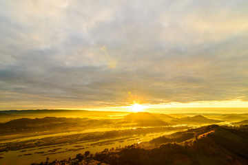 Landscape of golden sunrise morning with fog on mountain