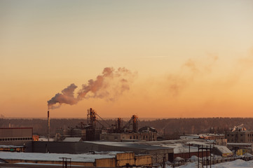 Industrial buildings at sunrise. Warehouses. Smoke from the pipe. Gradient.