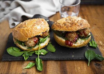 Vegan falafel burgers with spinach leaves and tomato sauce