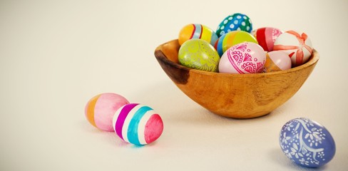 Fototapeta na wymiar Colorful Easter eggs in wooden bowl