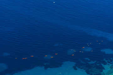 Fototapeta na wymiar Kayaks at sea. Tourist kayaking in the sea near Dubrovnik, Croatia. Aerial Photo drone.