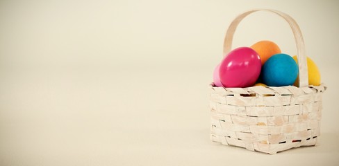 Various Easter eggs in wicker basket