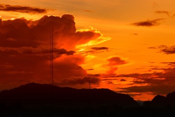 sunset in sky and cloud, beautiful colorful twilight time with mountain silhouette