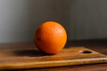 Juicy orange on a wooden board.