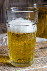 Glass of light beer with foam