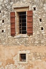 Fototapeta na wymiar Wall and windows of the Orthodox monastery on the island of Crete.
