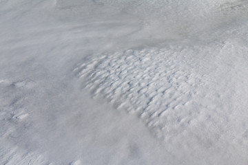 Nature patterns - snow and ice shaped by wind. High angle.
