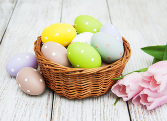 Basket with easter eggs and tulips