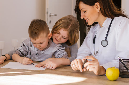 Beautiful Female Doctor Watching How Do Kids Drawing