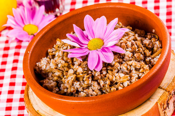 Buckwheat porridge in clay bowl