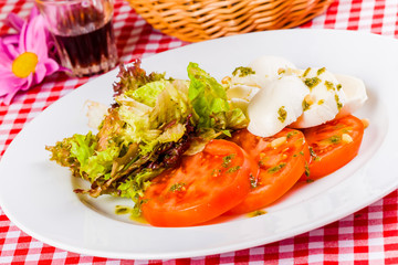 Caprese salad on white plate
