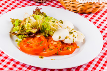 Caprese salad on white plate