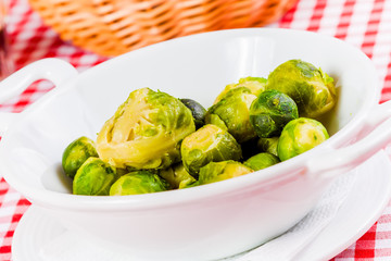 Boiled brussels sprouts in white bowl