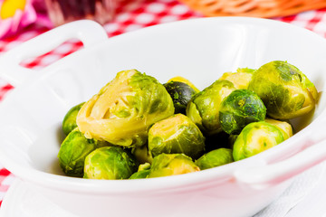 Boiled brussels sprouts in white bowl